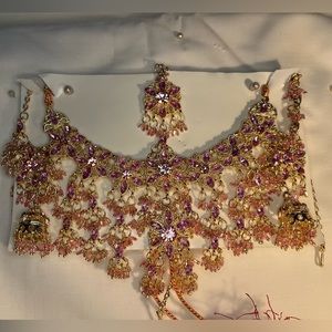 Pink necklace set with earrings and head piece.